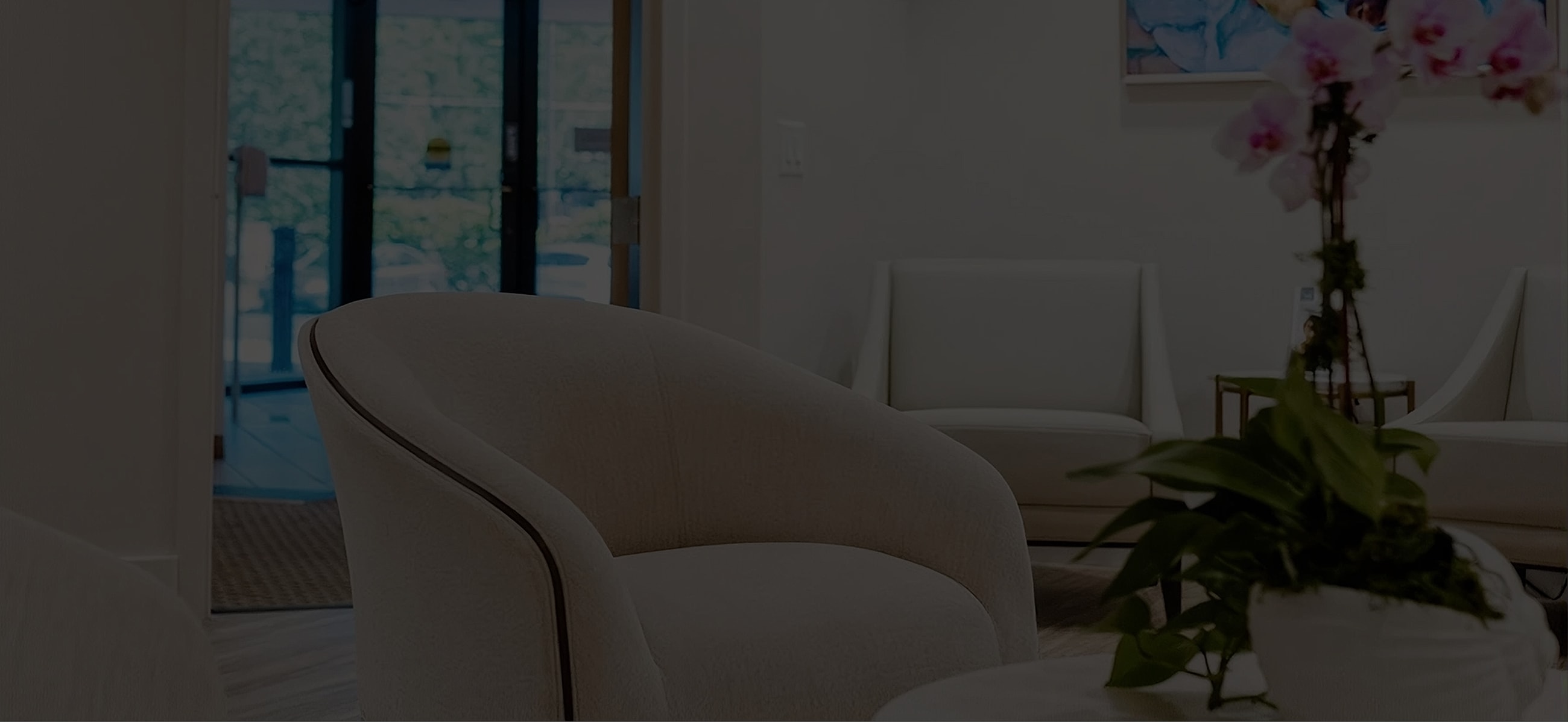 Cozy waiting area with modern seating and plants.