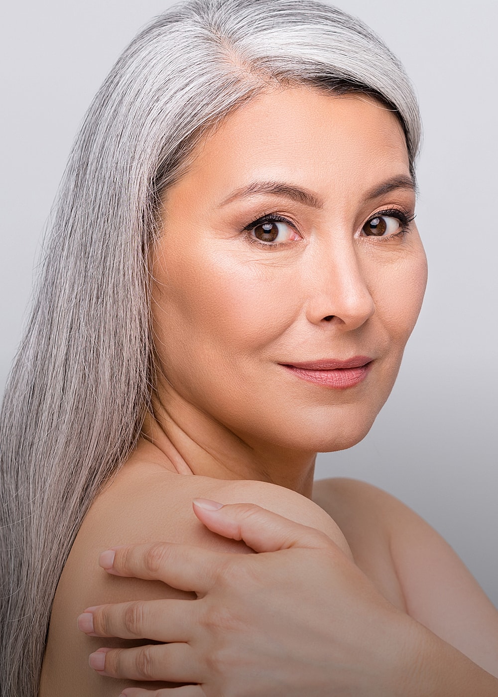 Charlotte, NC plastic surgery model with silver hair.