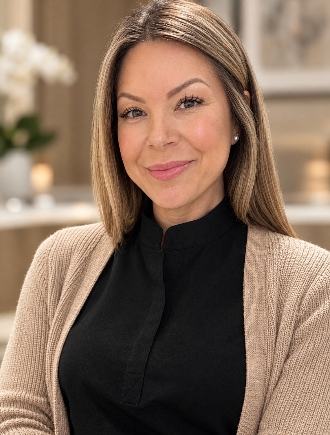 Smiling woman in a cozy sweater backdrop.