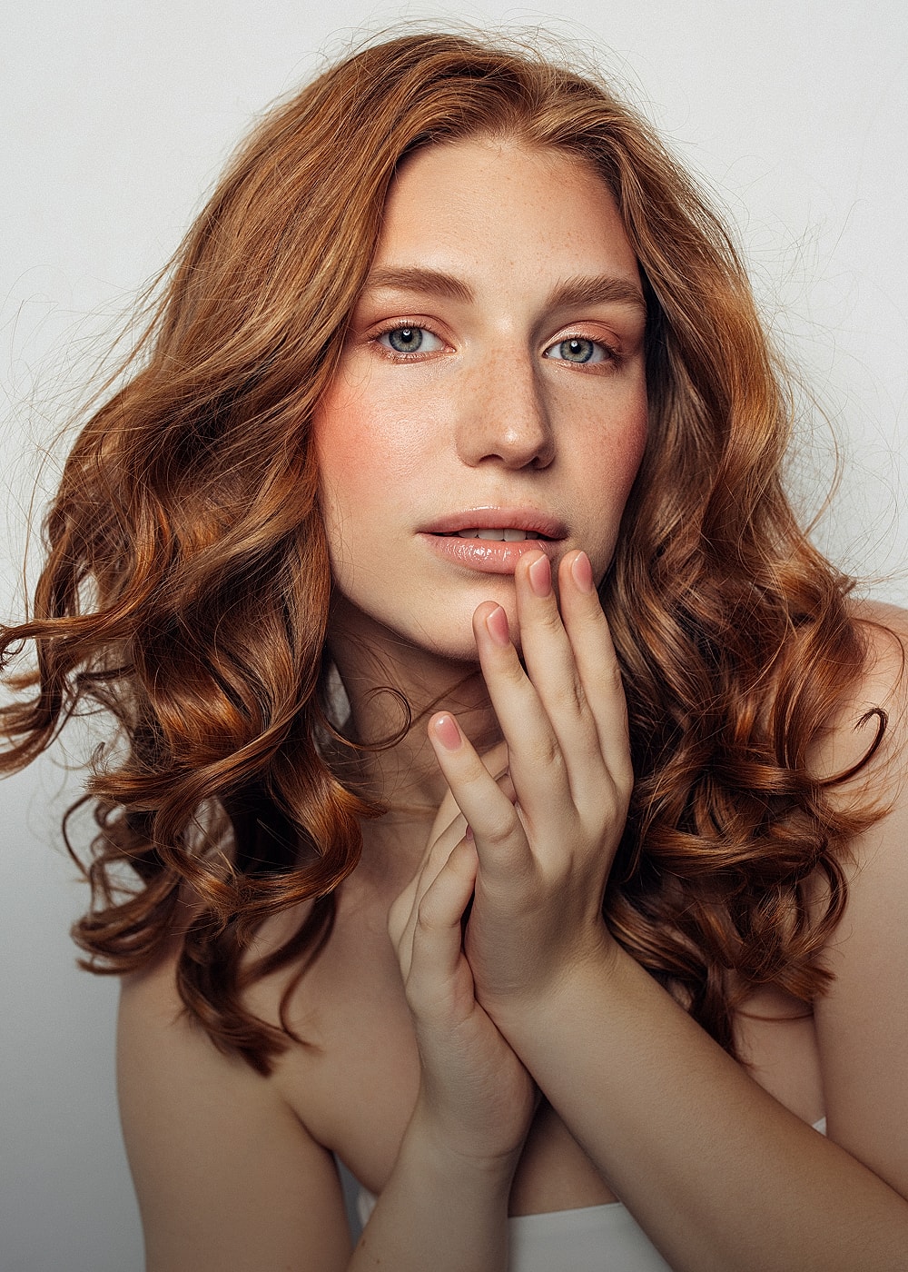 Charlotte, NC plastic surgery model with curly red hair.