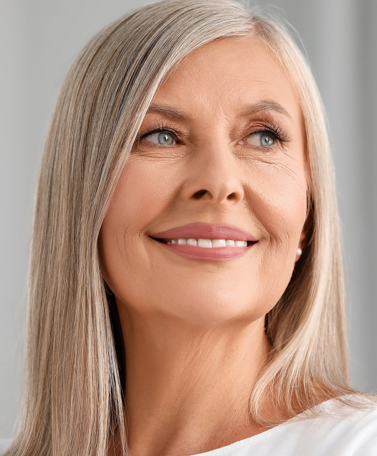 Charlotte, NC blepharoplasty model with long gray hair.