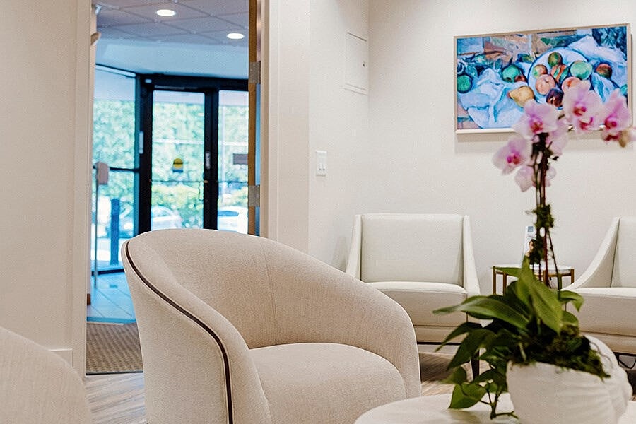 Modern waiting area with artwork and plants.